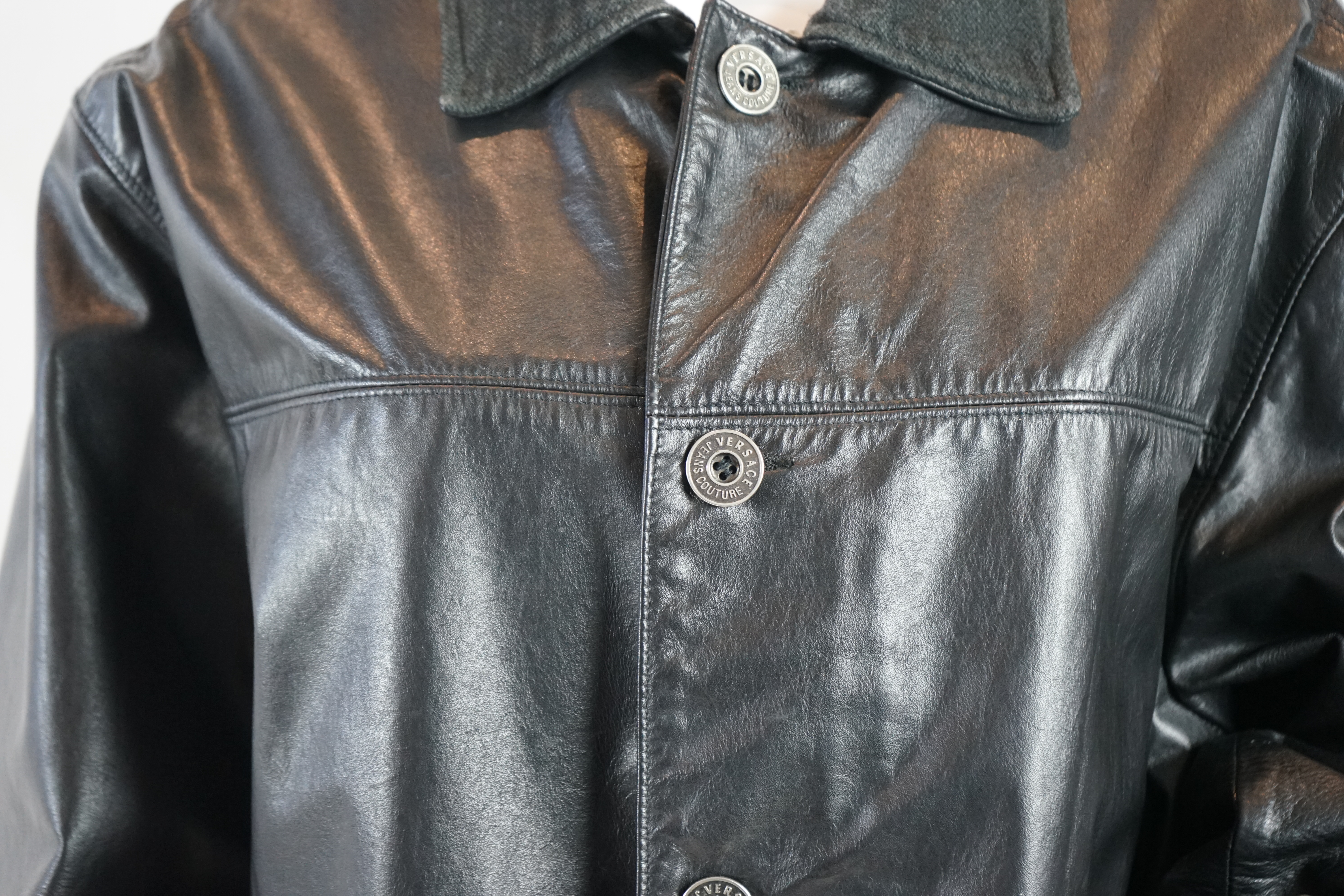 A Versace Jeans Couture men's black leather jacket and a Donna Karan men's black leather jacket, Size L
